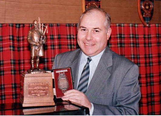 Mr Russell pictured with the MacDoigall Gillies Trophy and Medal