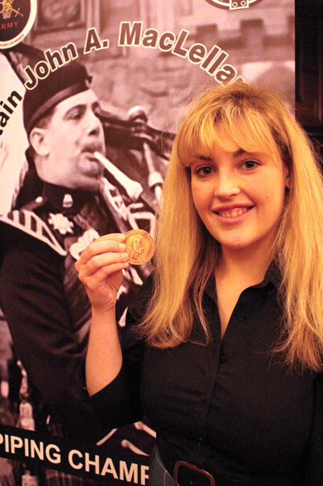 Champio Piper Faye Henderson poses with the prestigious John Maclellan Memorial Medal