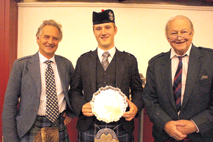 Last year's MacGregor Memorial winner Cameron MacDougall now competes for the 2015 Silver Medal. Cameron is pictured with Jamie Mellor, AG Piping Steward, and MacGregor organiser Angus Nicol