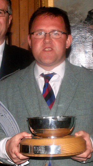 Tom Peterkin with the Archie Kenneth Quaich on an earlier occasion. With him are fourth prize winner John Frater, Alan Forbes, Piobaireachd Socoety Music Committee Secretary and competitor James Kenny