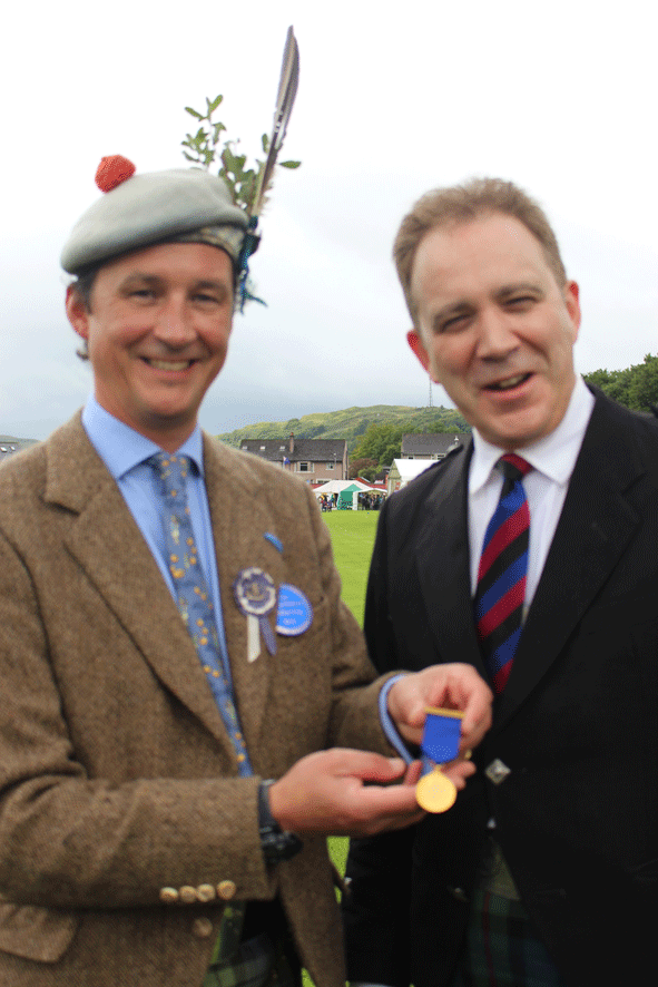 John Angus receives his medal from the Duke of Argyll
