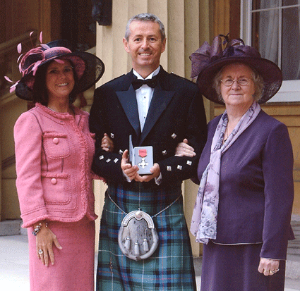 Richard pictured with his wife and mother when he received his MBE for services to music