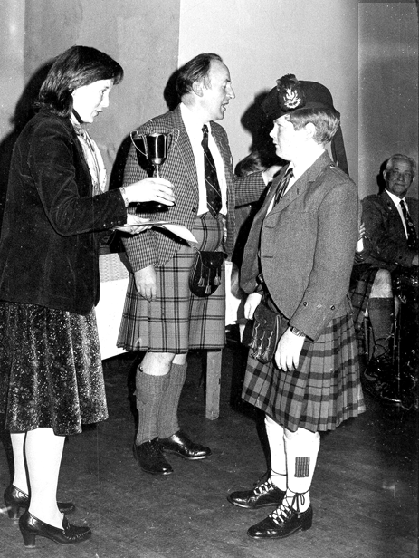 Alasdair receiving one of the fiurst of many trophies at the Northern Meeting. This historic picture was taken in 1978. Standing behind the trophy is the NM's fondly r-remembered Piping Secretary of the day. Ross Martin. Looking on with pleasure is the great P/M Donald MacLeod 