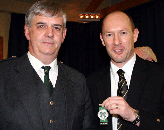 2011....Iain Speirs (r) receives the Glasgow Highland Club Medal from the club's Simon Pender 