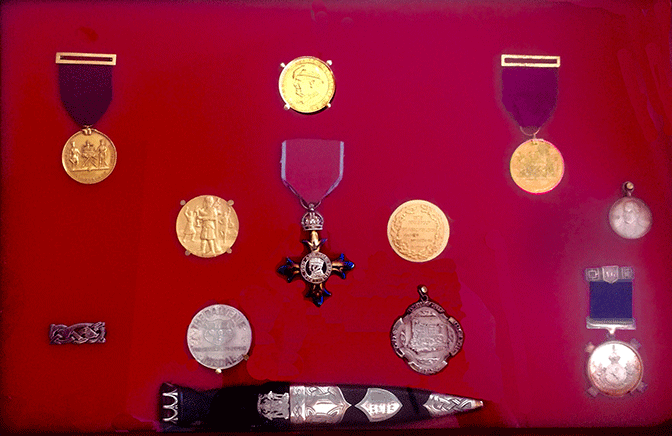 Some of Jimmy McIntosh's awards....in the centre is his MBE; either side of that are two Braemar Gold Medals; above it is a copy if the RU Brown medal from the RU Brown Piob. Soc. of South Australia; below it left is the Balvenie Medal for services to piping; below right is the Dunvegan Medal; far left is the Clasp to this medal; bottom is the Glenfiddich Champions' sign dubh; far right is the Argyllshire Gathering Medal for Marches; above it is a small medal he received at school, for reciting Burns' poetry