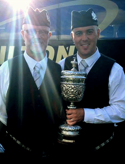 Shining lights....Terry Tullky and his son P/M Alen with the handsome European Pipe Band Champions trophy