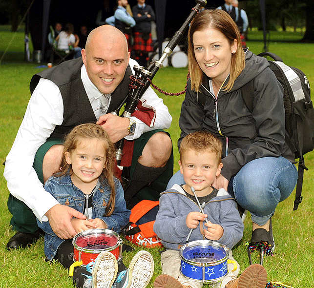 St Laurence O'Toole pipe major Alen Tully spends a few moments away from band duties with his wife Michelle pictured with their children Emilia and Alex... surely not drummers Alen!