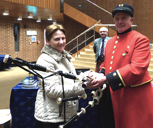 Ann receives her D Naill pipes from Chelsea pensioner Davy MacIntyre