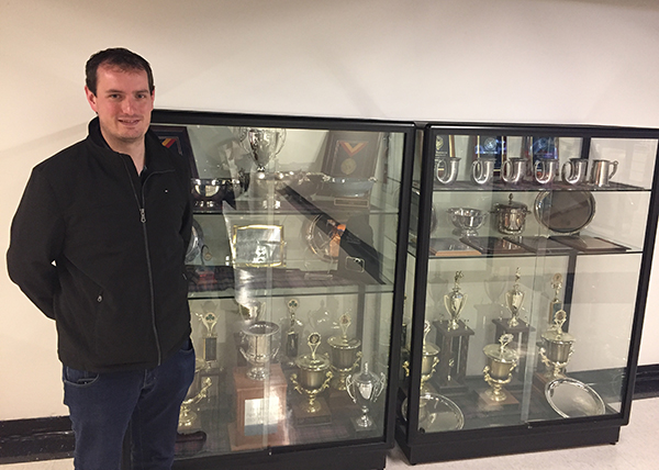 Andrew at the CMU Pipe Band's trophy cabinet